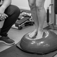 Balance exercise with bosu ball, woman and doctor in gym. Balance exercise with bosu ball, woman and doctor in gym.